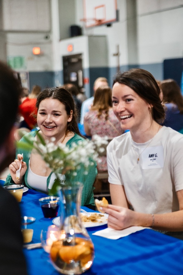 Two women laughing together at a table